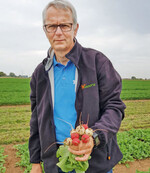 Hazera-Geschäftsführer Joachim Middendorf mit einem Bündel gemischtfarbener Radies.